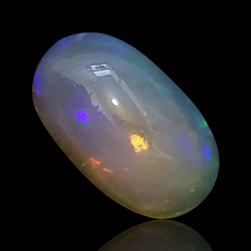 5Ct Natural Ethiopian Opal Cabochon. Size is approx. 15x9mm.